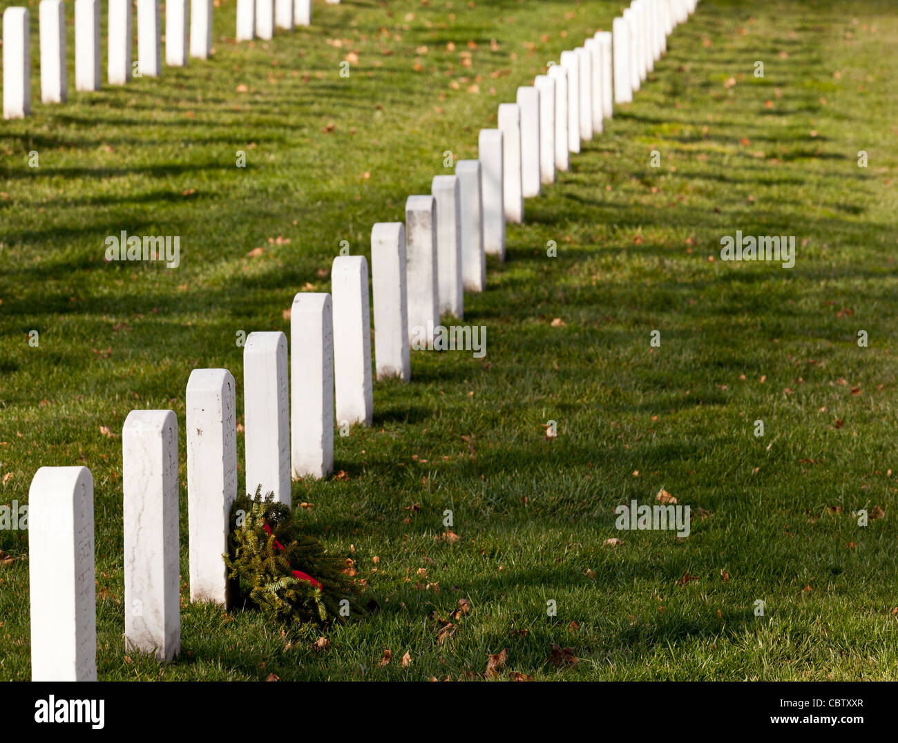 Christmas wreaths on gravestones in Arlington National Cemetery. The wreathes have been donated each year since 1992. Stock Photo
