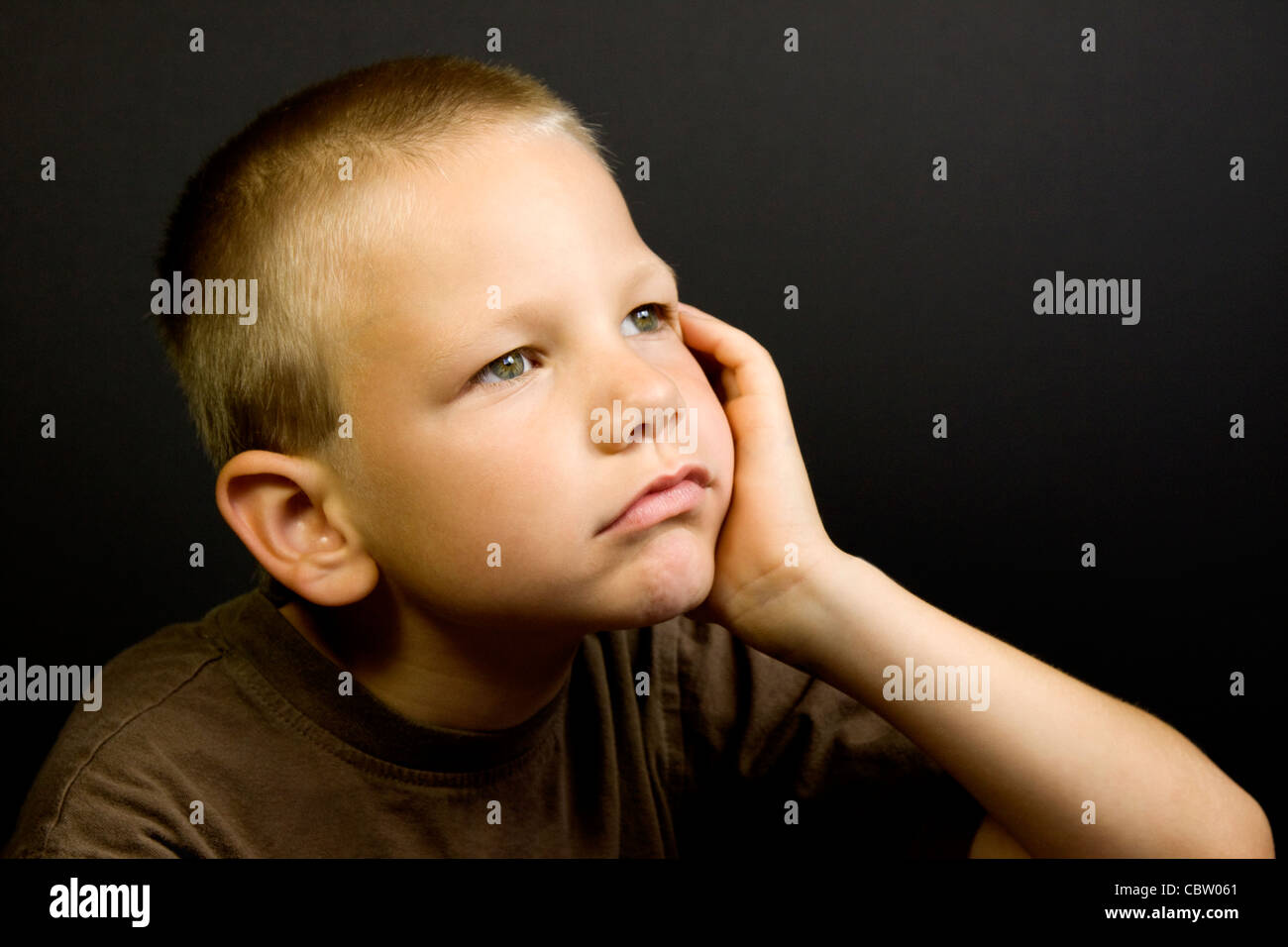 Young boy day dreaming Stock Photo
