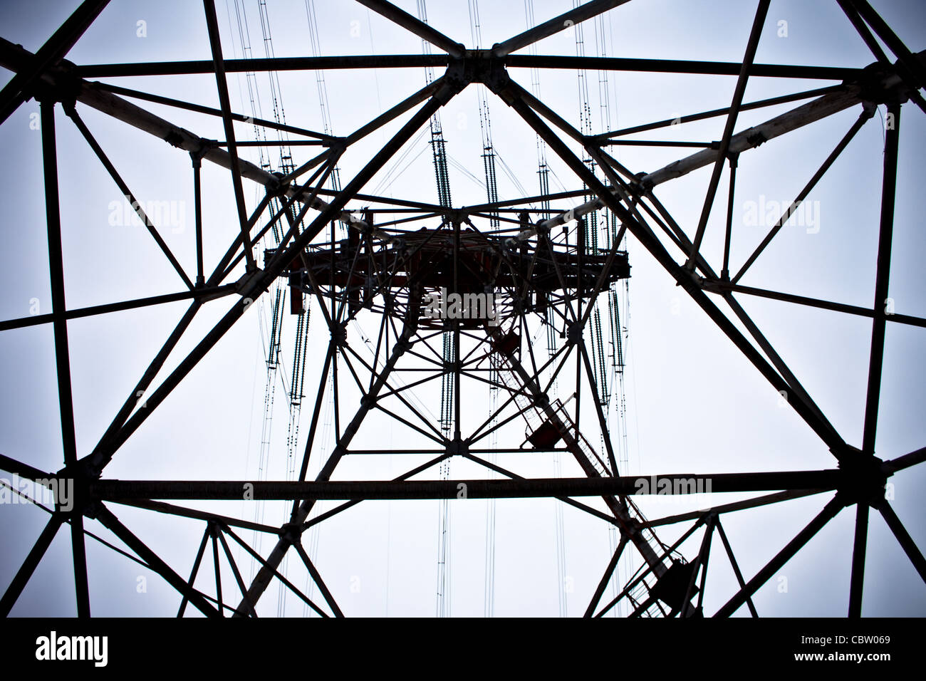 power lines tower with blue sky in background Stock Photo - Alamy