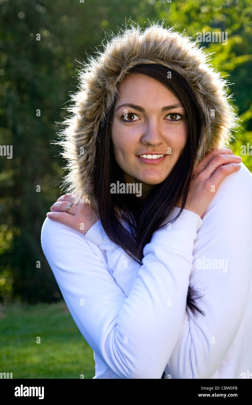 Beautiful young woman enjoying fall weather outdoors Stock Photo