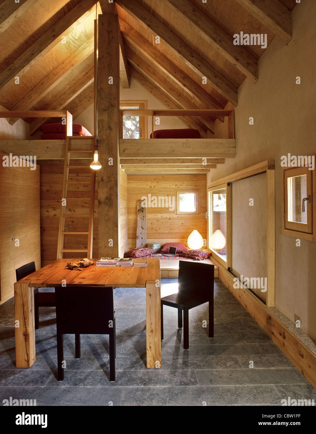 Interior Of Chalet With Dining Table And Sleeping Loft Stone