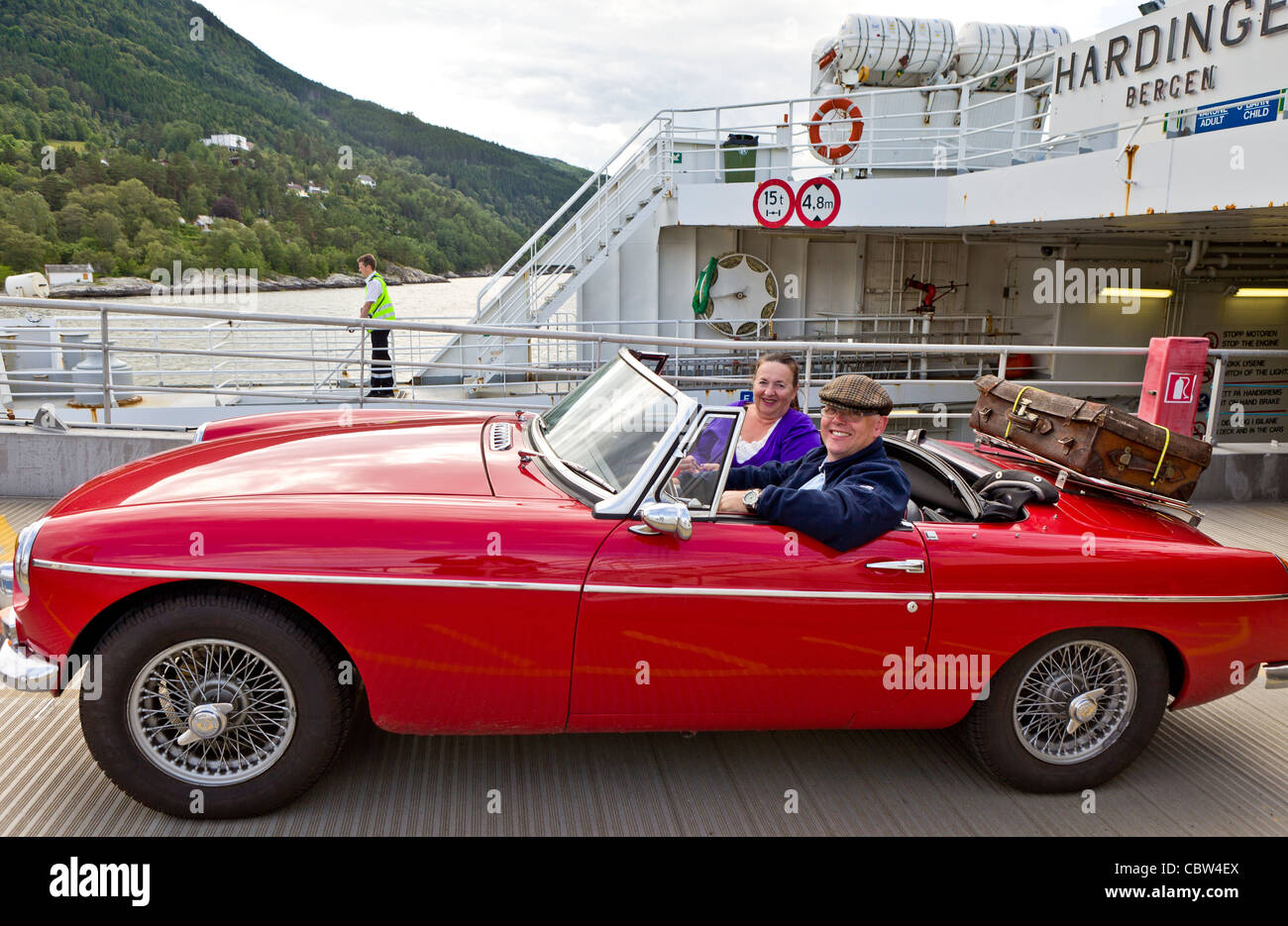 Couple in convertible- Utne Ferry, Norway Stock Photo