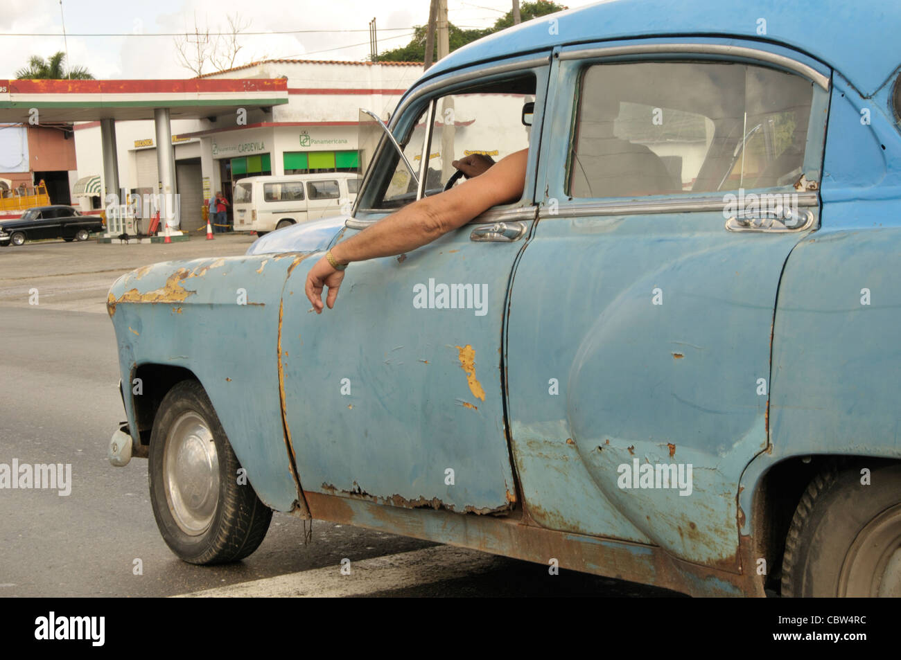 Man's harm in a decadent old car in Havana town, Cuba Stock Photo
