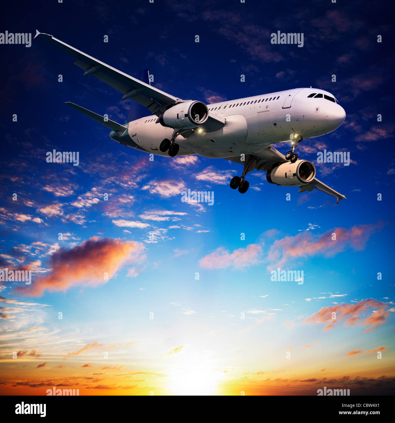 Jet plane in a sunset sky. Square composition Stock Photo Alamy