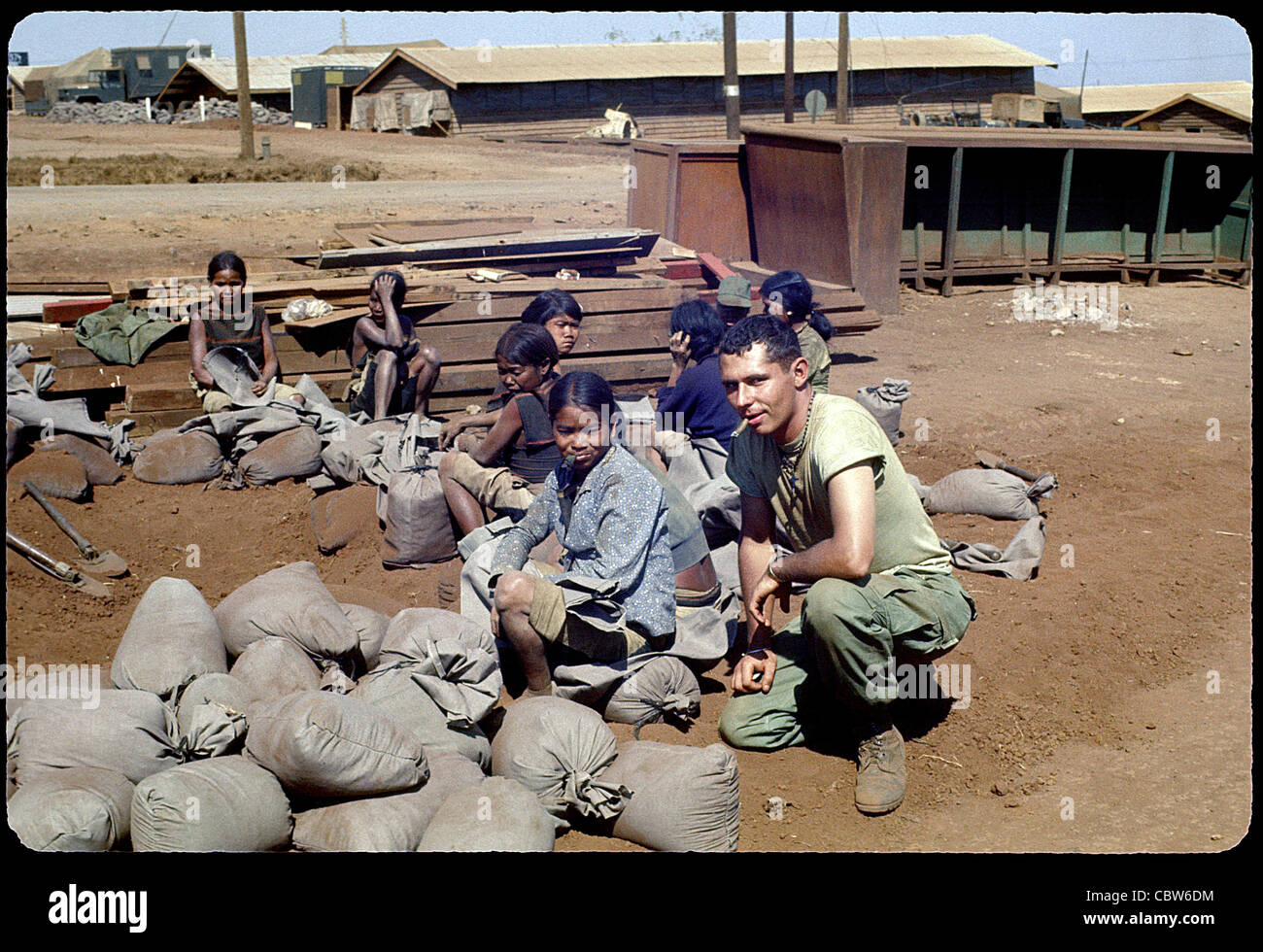 GI posing with montagnards in the 4th Infantry Division's area of operations vietnam war pleiku Stock Photo