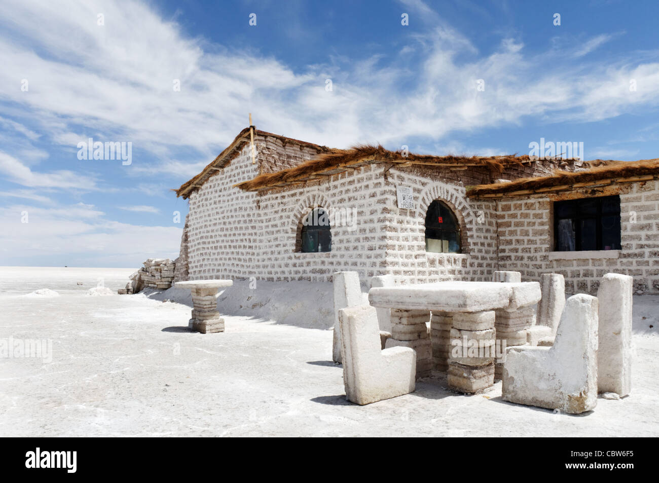 The outside of a salt hotel, with salt chairs and tables, in Salar de Uyuni, Bolivia Stock Photo