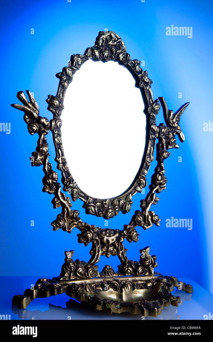 Composition of an ancient mirror accomplished in study Stock Photo