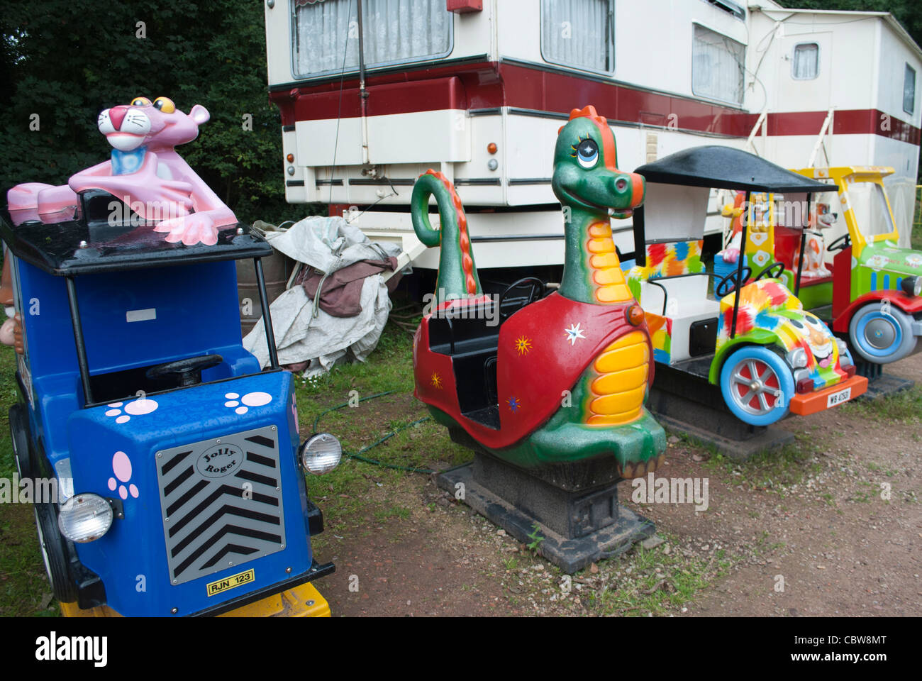 A Row Of Small Kiddie Rides In Front Of Caravans In Fairground At The 