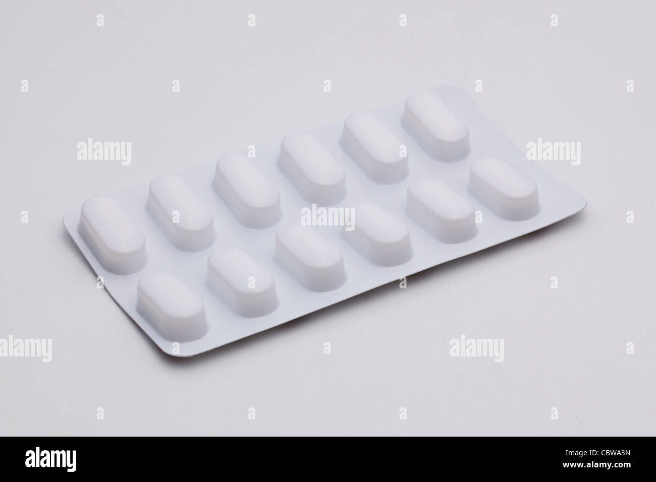 White Pills in blister on gray Stock Photo