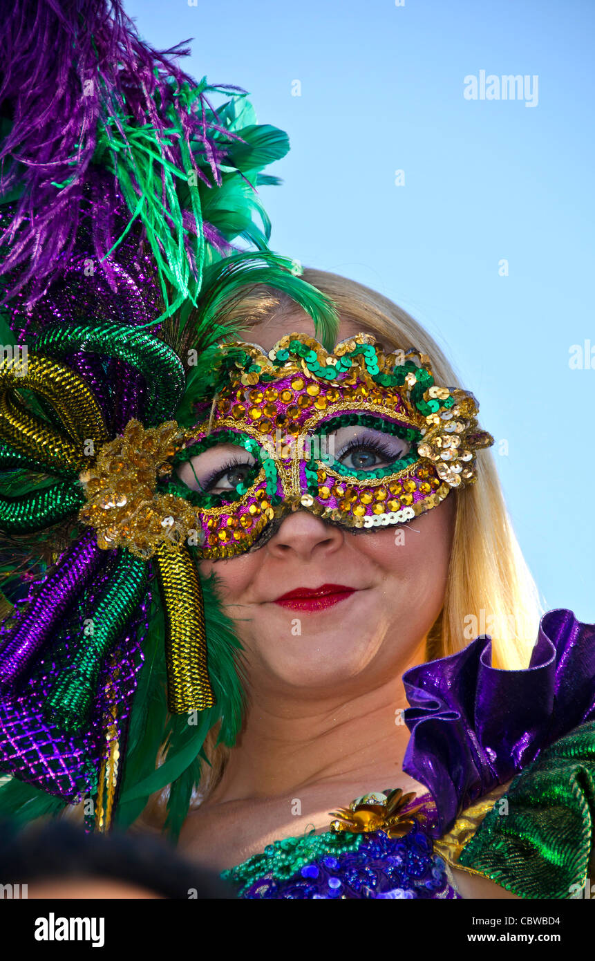 Woman wearing colorful Mardi Gras mask at Universal Studios Orlando annual Mardi Gras ...