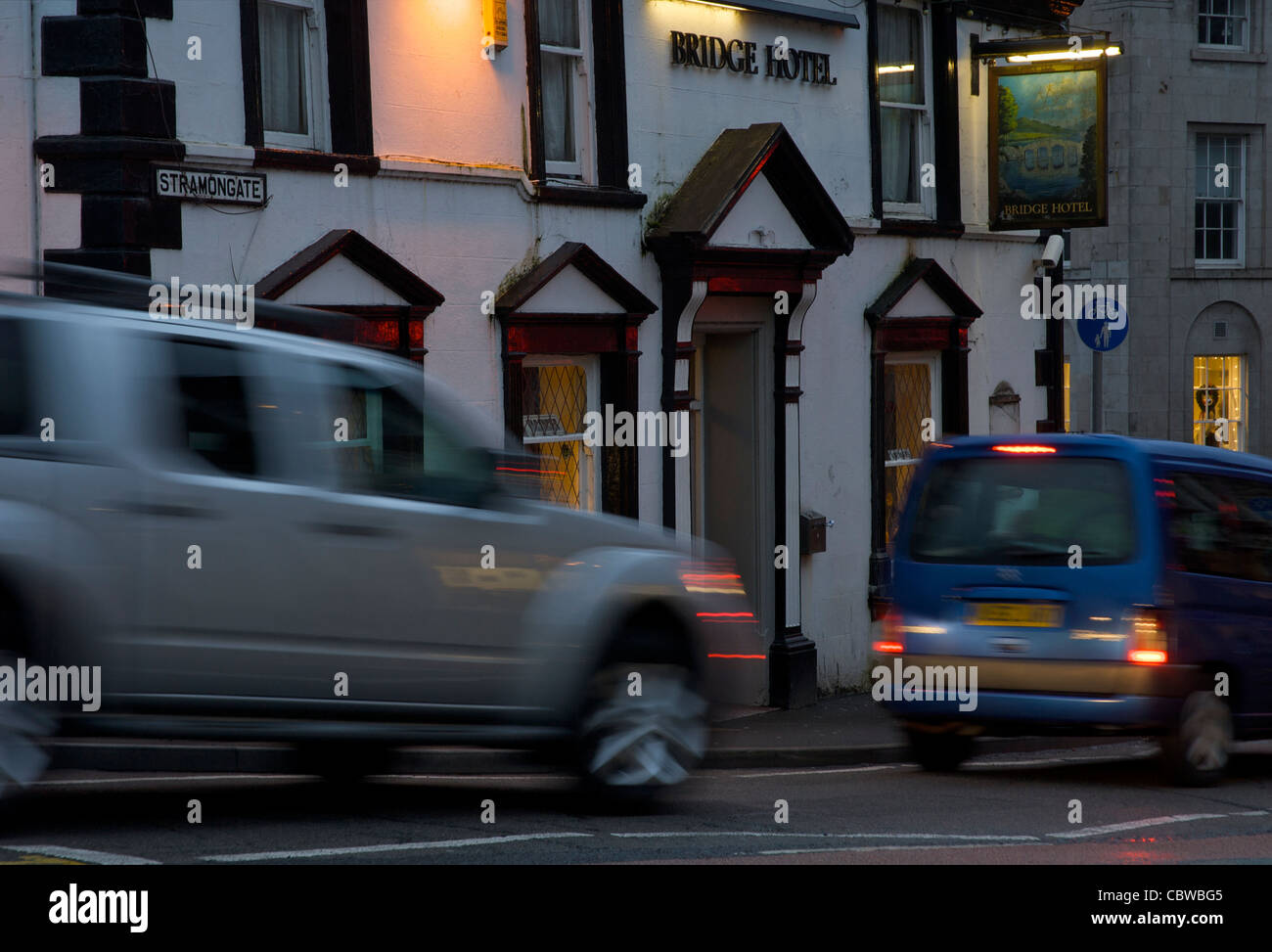 Cars passing the Bridge Hotel, Stramongate, Kendal, Cumbria, England UK