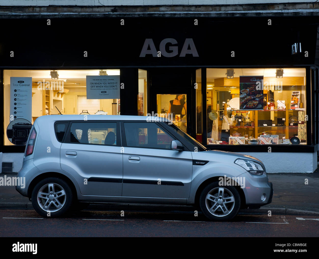Car parked in front of the Aga shop at night, Kendal, Cumbria, England