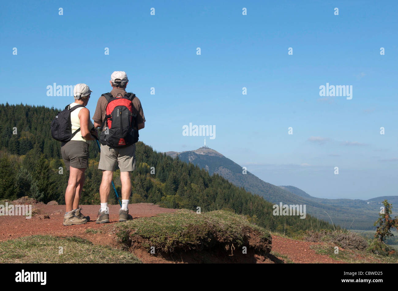 Couple hiking in the Auvergne - over looking the Puy de Dôme / Puy-de-Dome volcano, France. Stock Photo