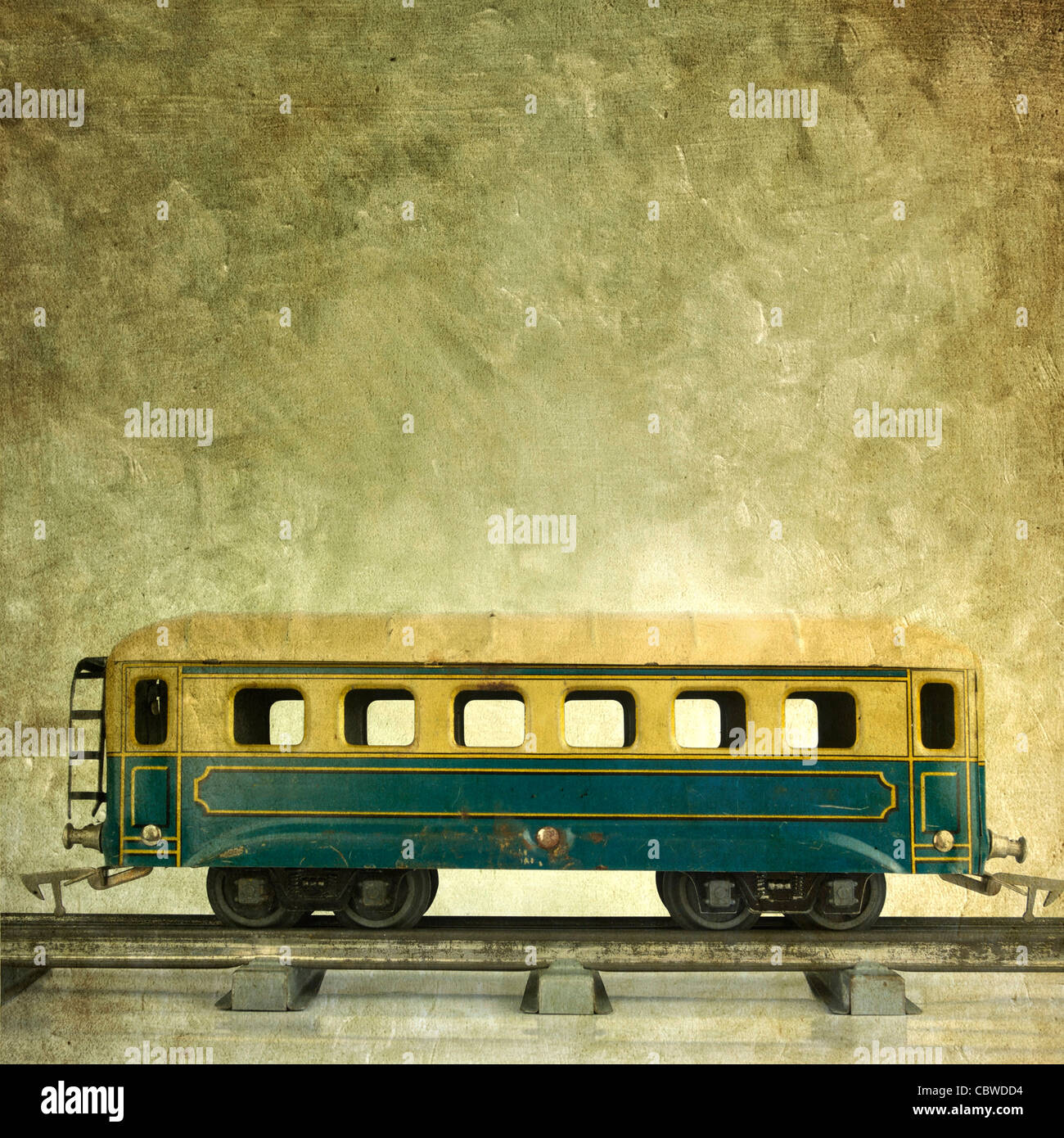 Vintage train carriage on track against a textured backdrop in a nostalgic setting Stock Photo