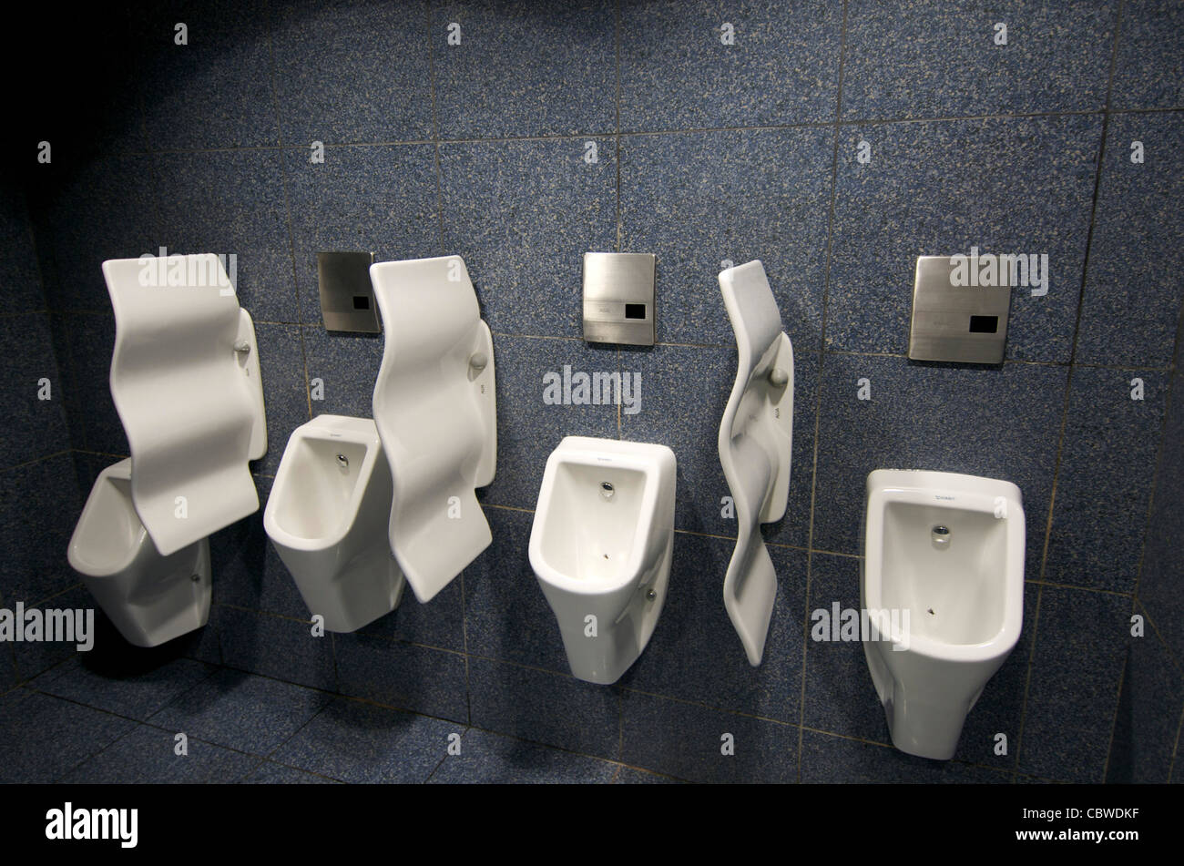 Urinals in gents public toilets. Stock Photo