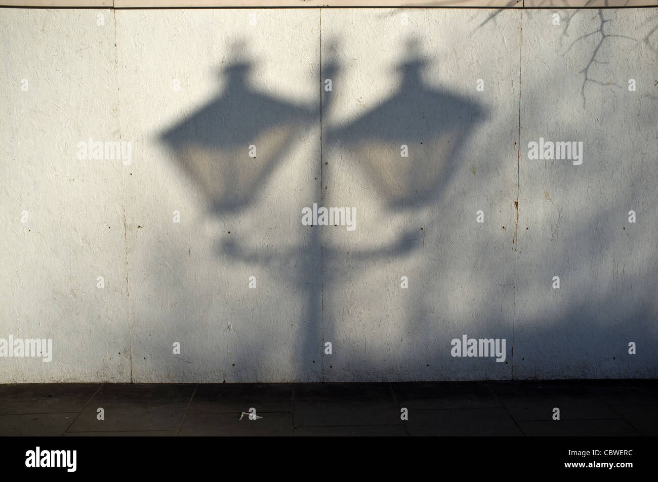 Shadow of old-fashioned lamp-post  on wall. Stock Photo