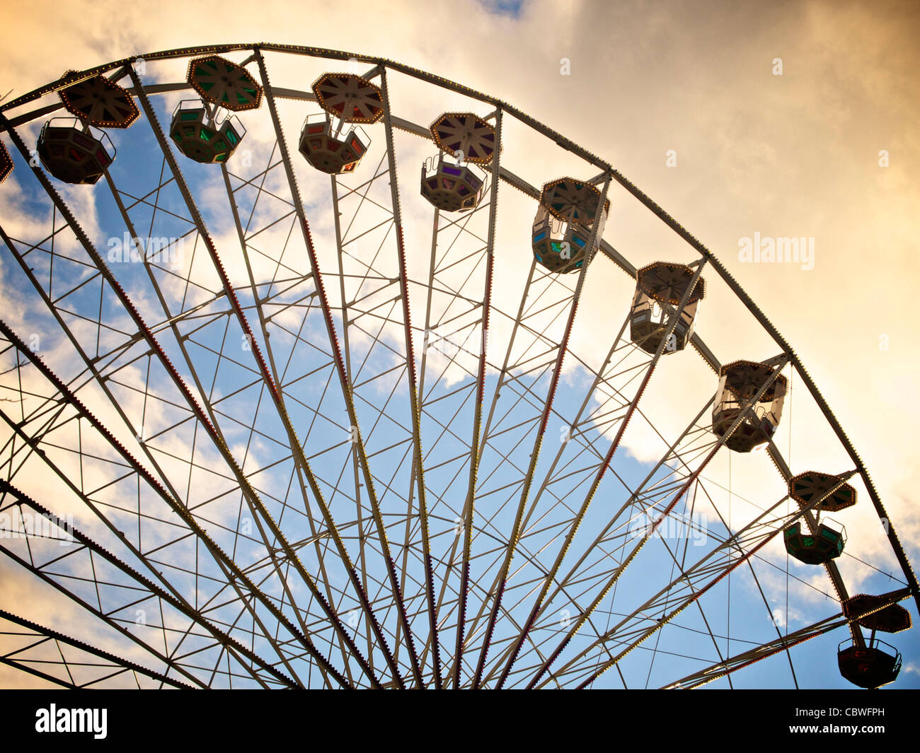 Low angle shot of a Ferris wheel captured at sunset Stock Photo