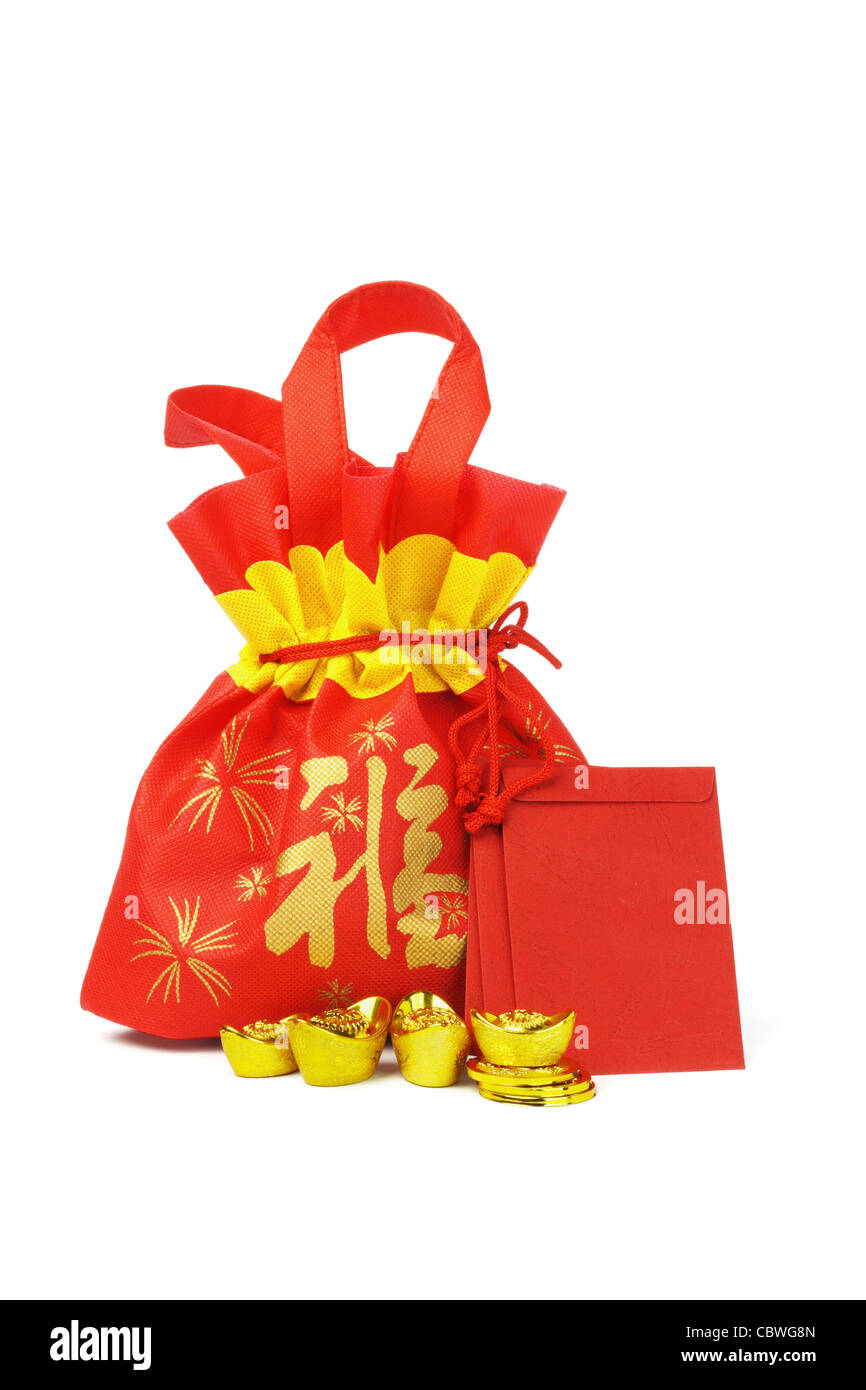 Chinese New Year gift bag, red packets, gold ingots and coins on white background Stock Photo
