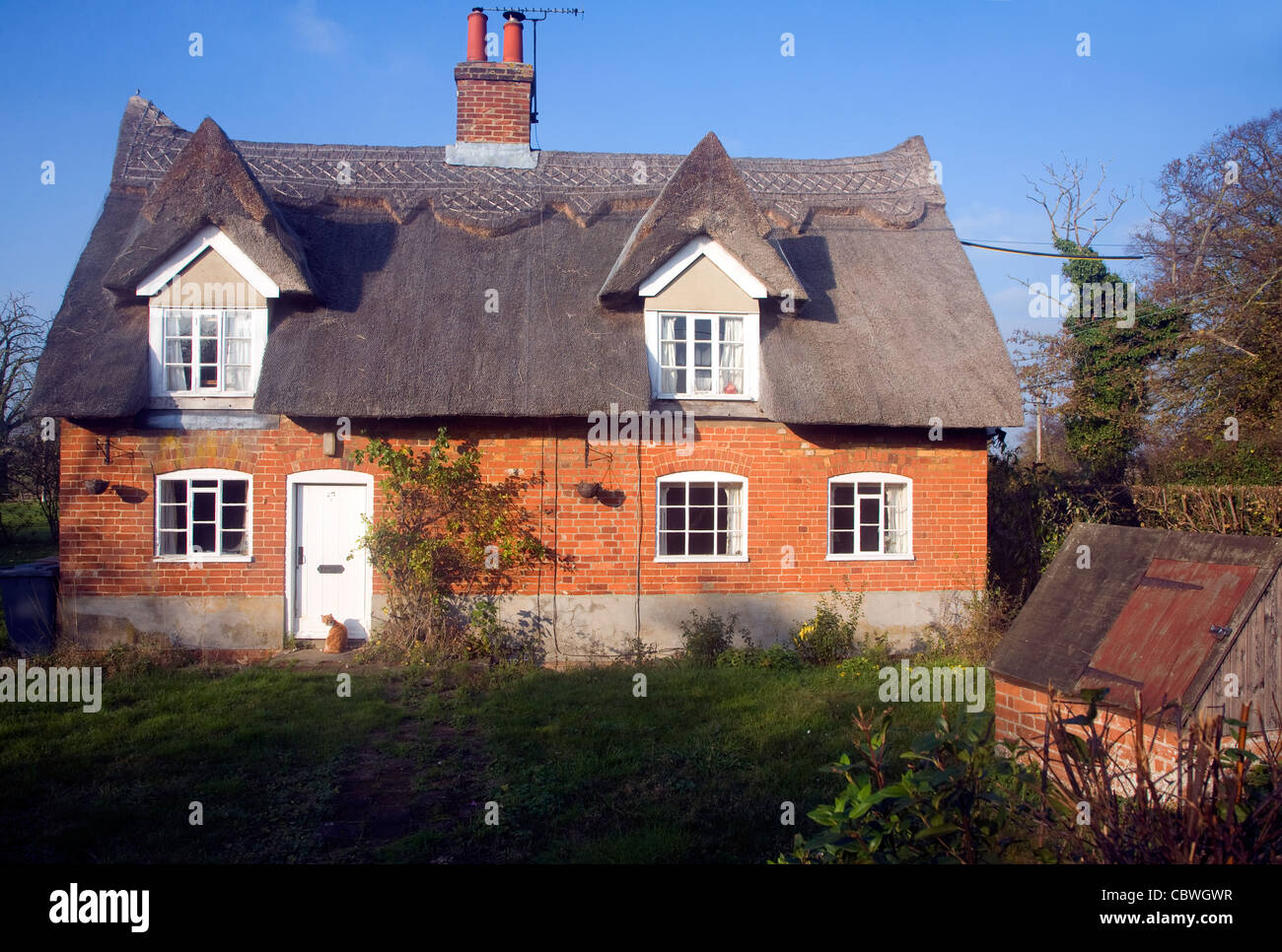 Thatched red brick country cottage, Sutton, Suffolk, England Stock Photo