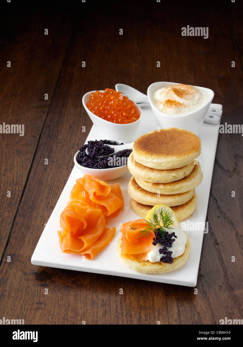 Blini with smoked salmon salmon roe and sour cream Stock Photo - Alamy