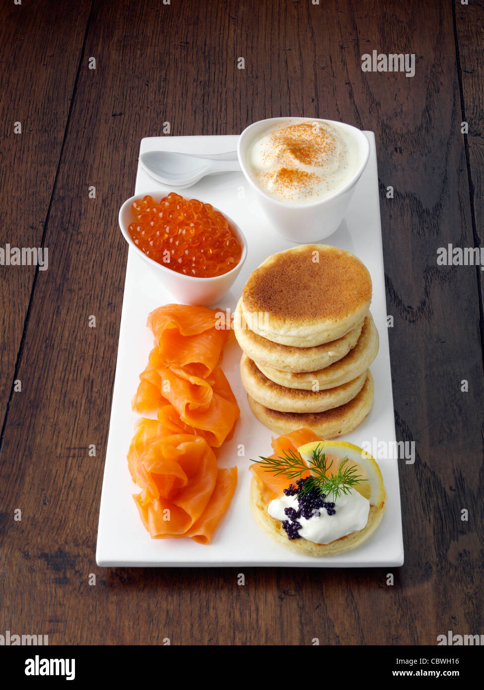 Blini with smoked salmon salmon roe and sour cream Stock Photo - Alamy