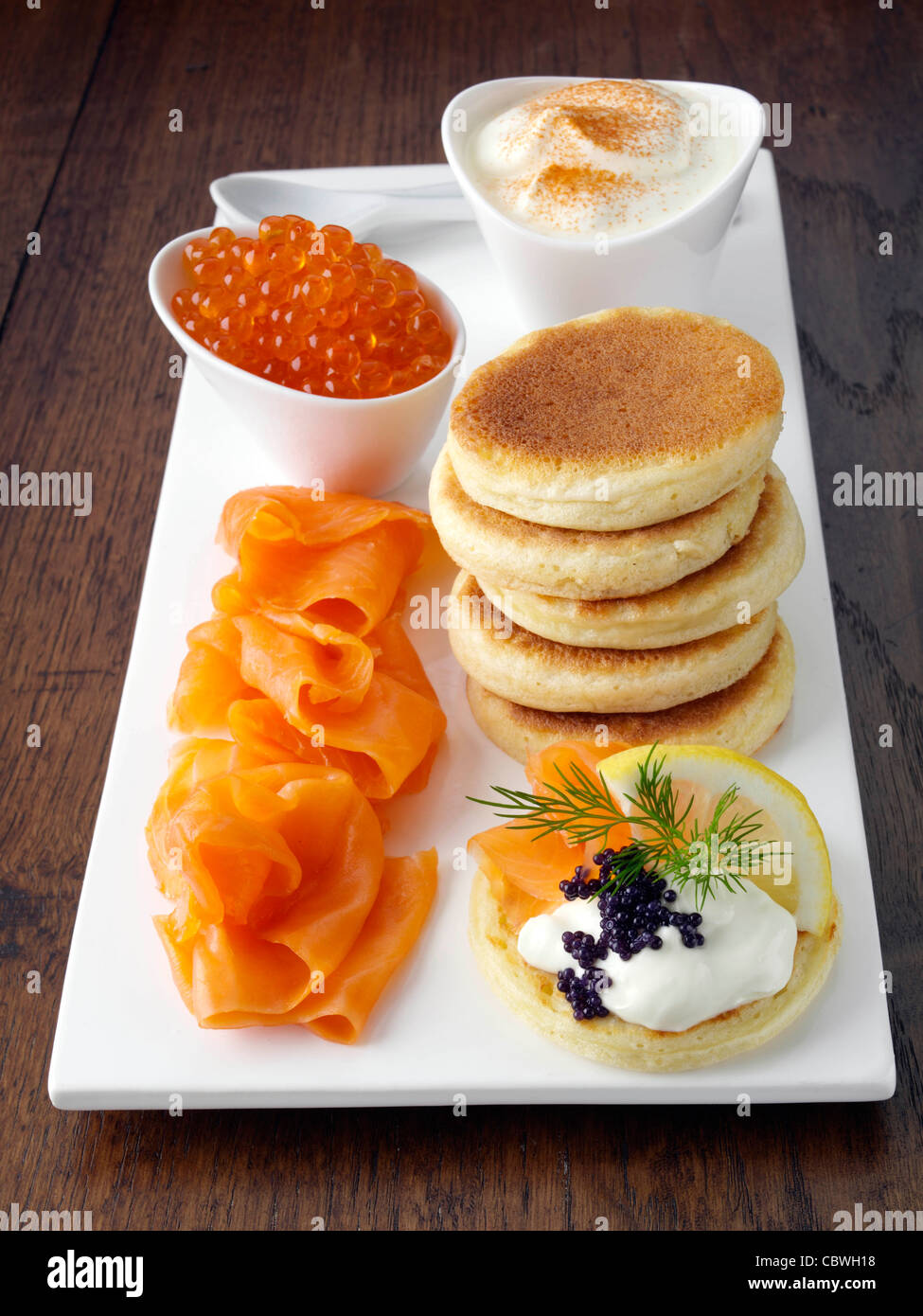 Blini with smoked salmon salmon roe and sour cream Stock Photo - Alamy