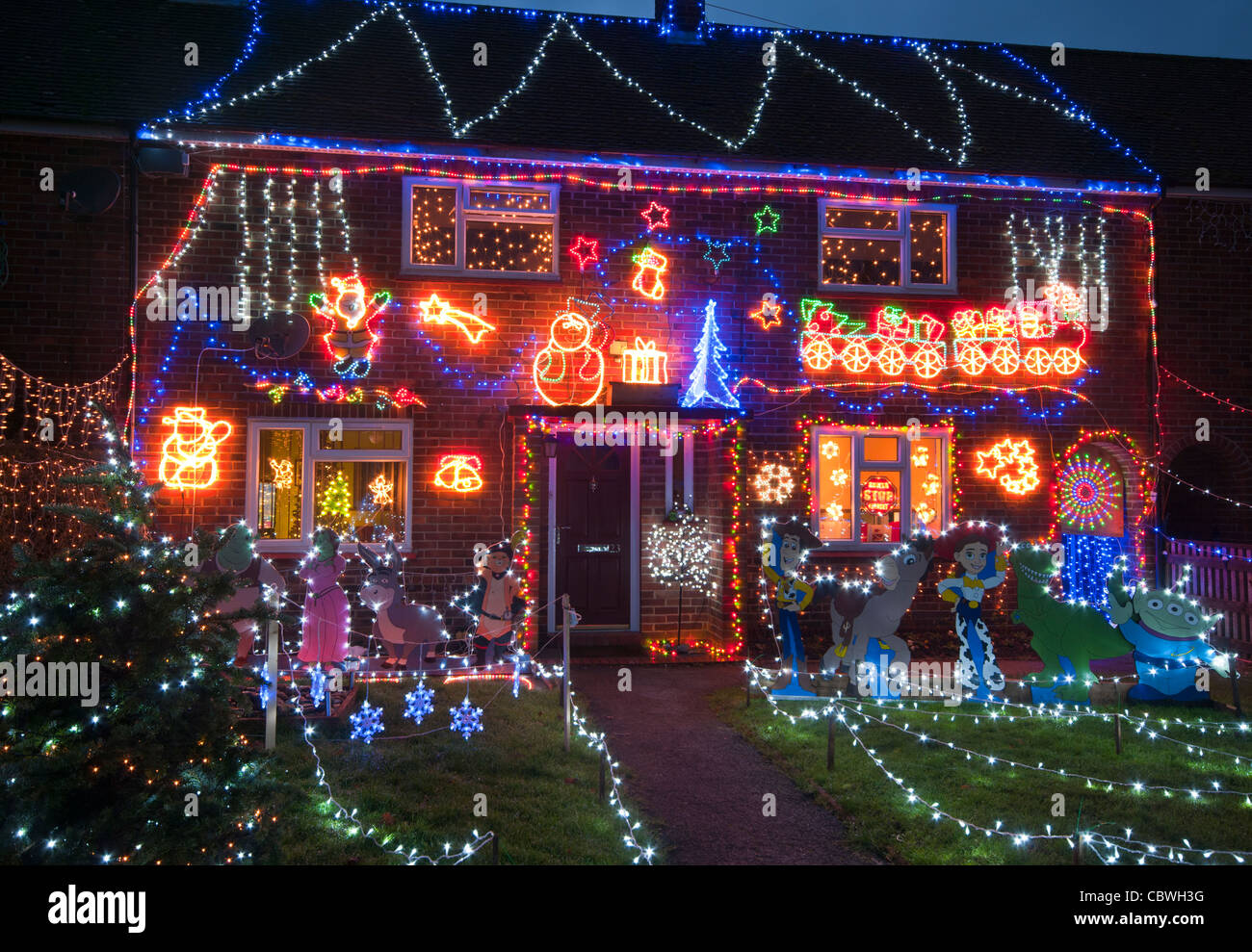 Exterior Of A House Lit Up With Christmas Lights At Dusk Home Property Illuminated Xmas Decorations At Night Stock Photo