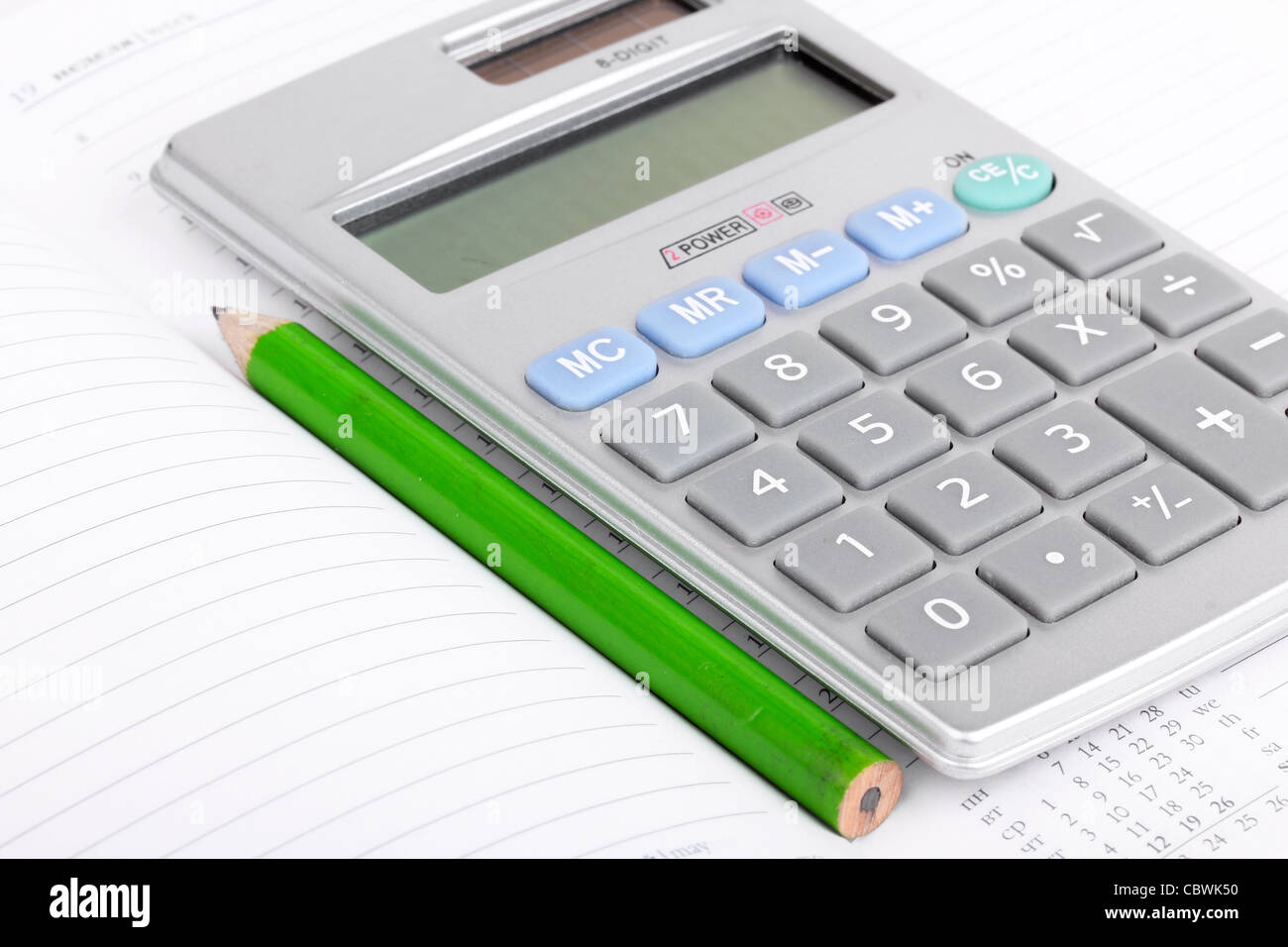 Calculator and pencil on notebook, closeup Stock Photo