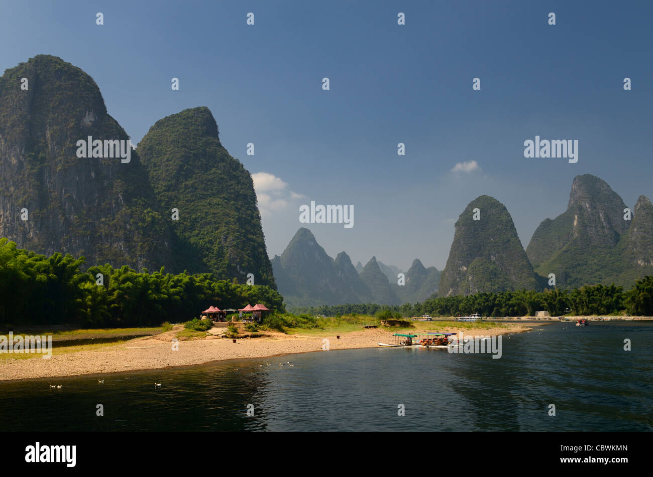 Boats and rest stop on the Li river with tall karst formations receding into the distance Peoples Republic of China Stock Photo