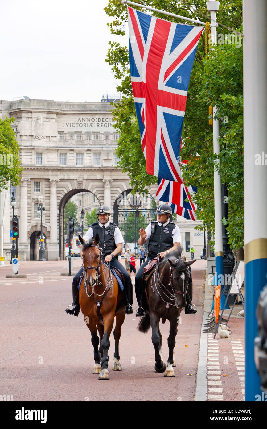 London polce officers riding horses on The Mall in front of the