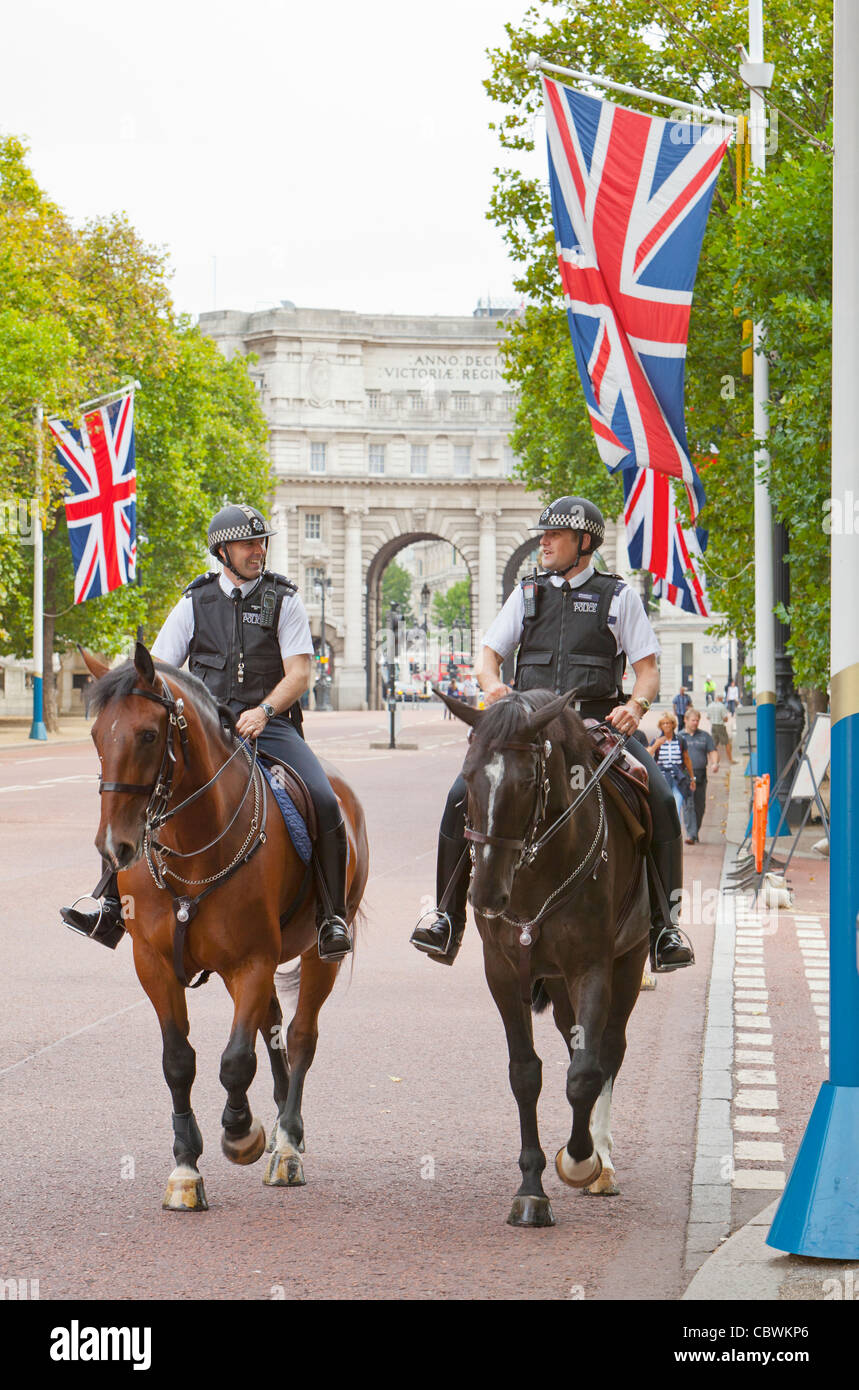 London polce officers riding horses on The Mall in front of the Admiralty Arch. Stock Photo