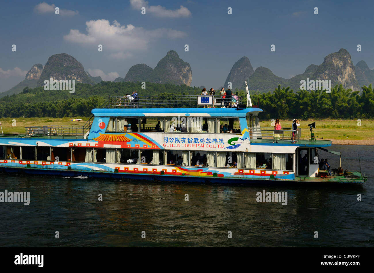 Chinese tour boat at Yangshuo on the Li river Guangxi China with bamboo ...