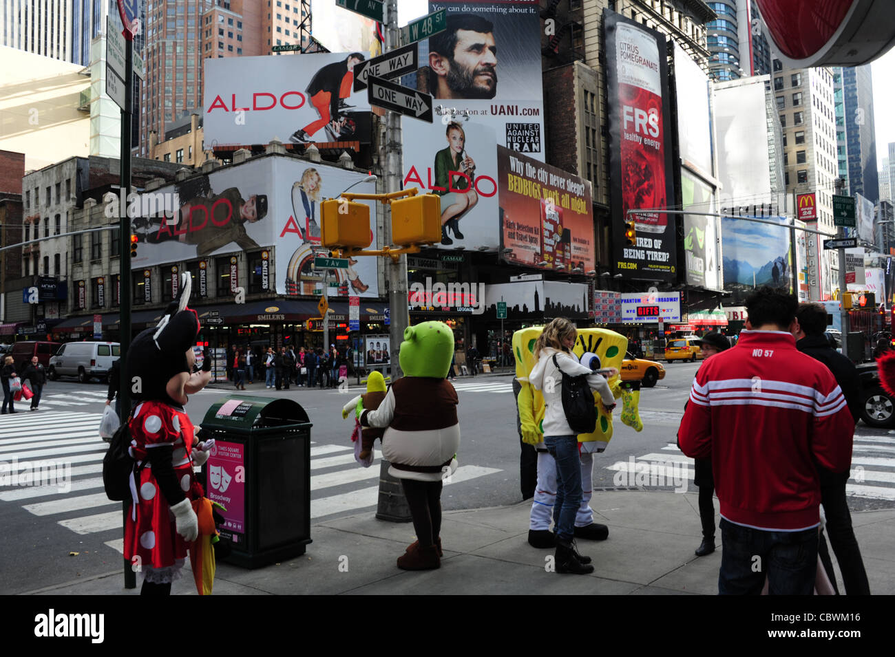 View people, billboards, entertainers (Minnie Mouse, Shrek, SpongBob) standing sidewalk, 7th Avenue West 48th Street, New York Stock Photo
