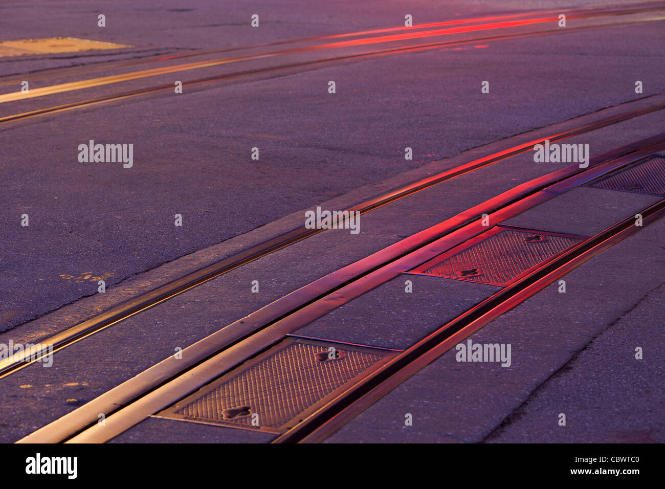 San Francisco historic cable car tracks at night with red and yellow neon light reflections Stock Photo