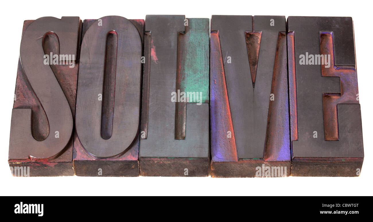 solve word in antique letterpress printing blocks, stained by color inks, isolated on white Stock Photo