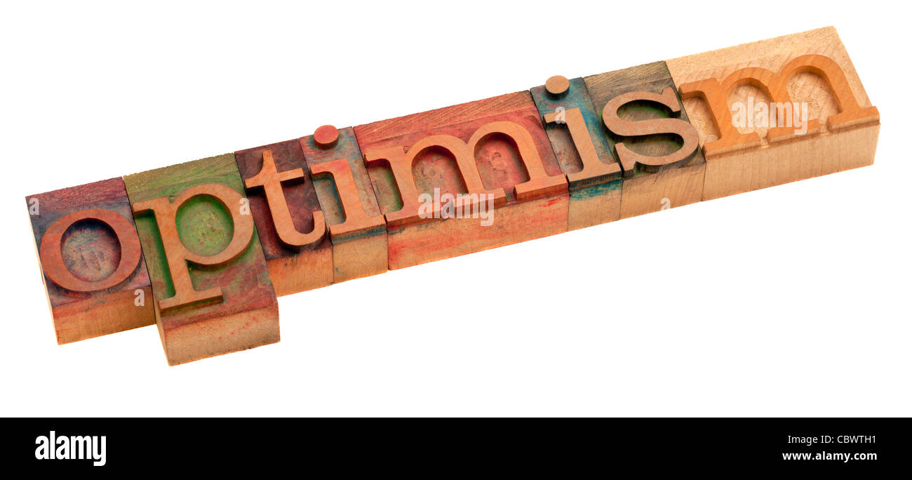 optimism word in vintage wooden letterpress printing blocks, stained by color inks, isolated on white Stock Photo