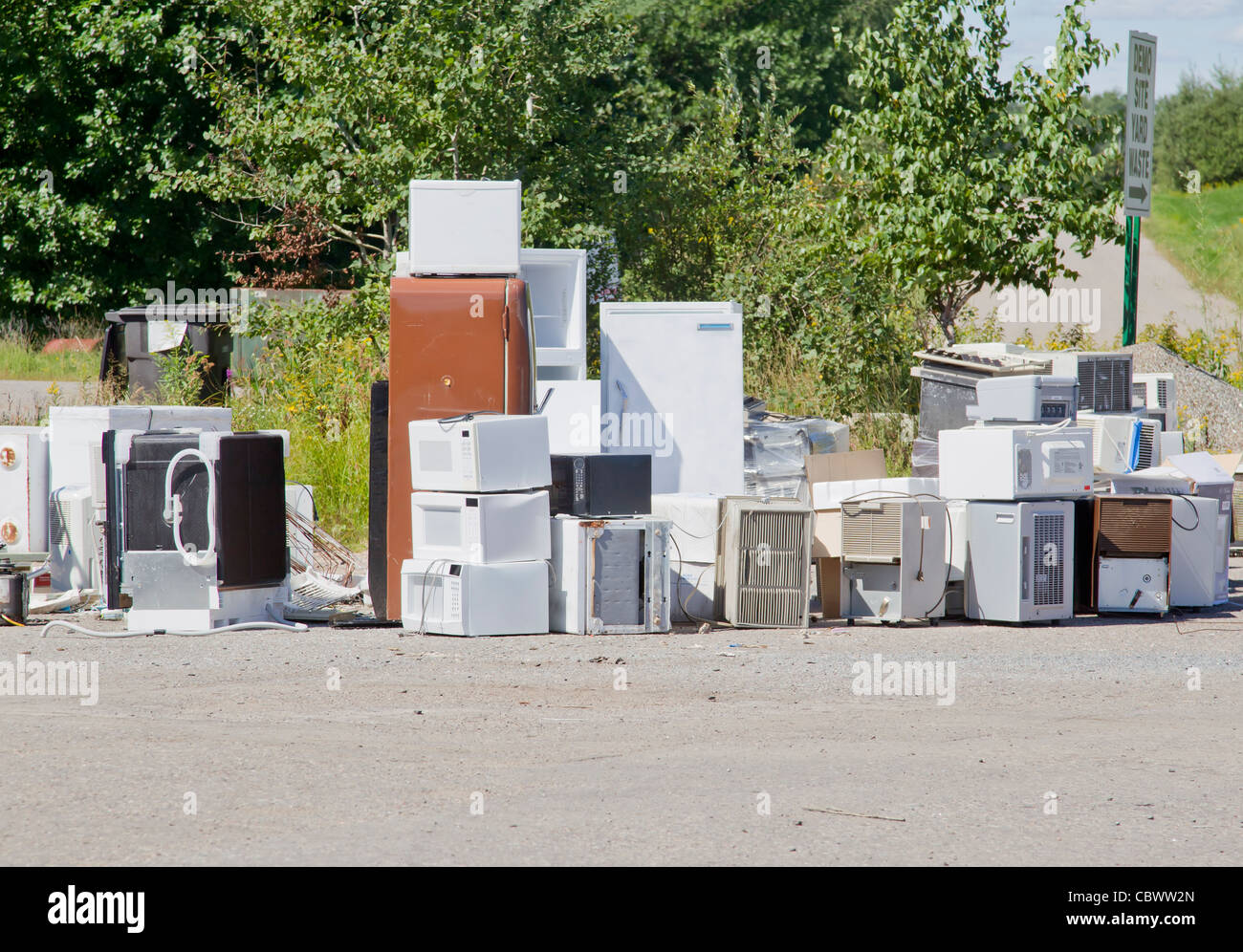 A stack of old appliances such as refrigerators, freezers, and air