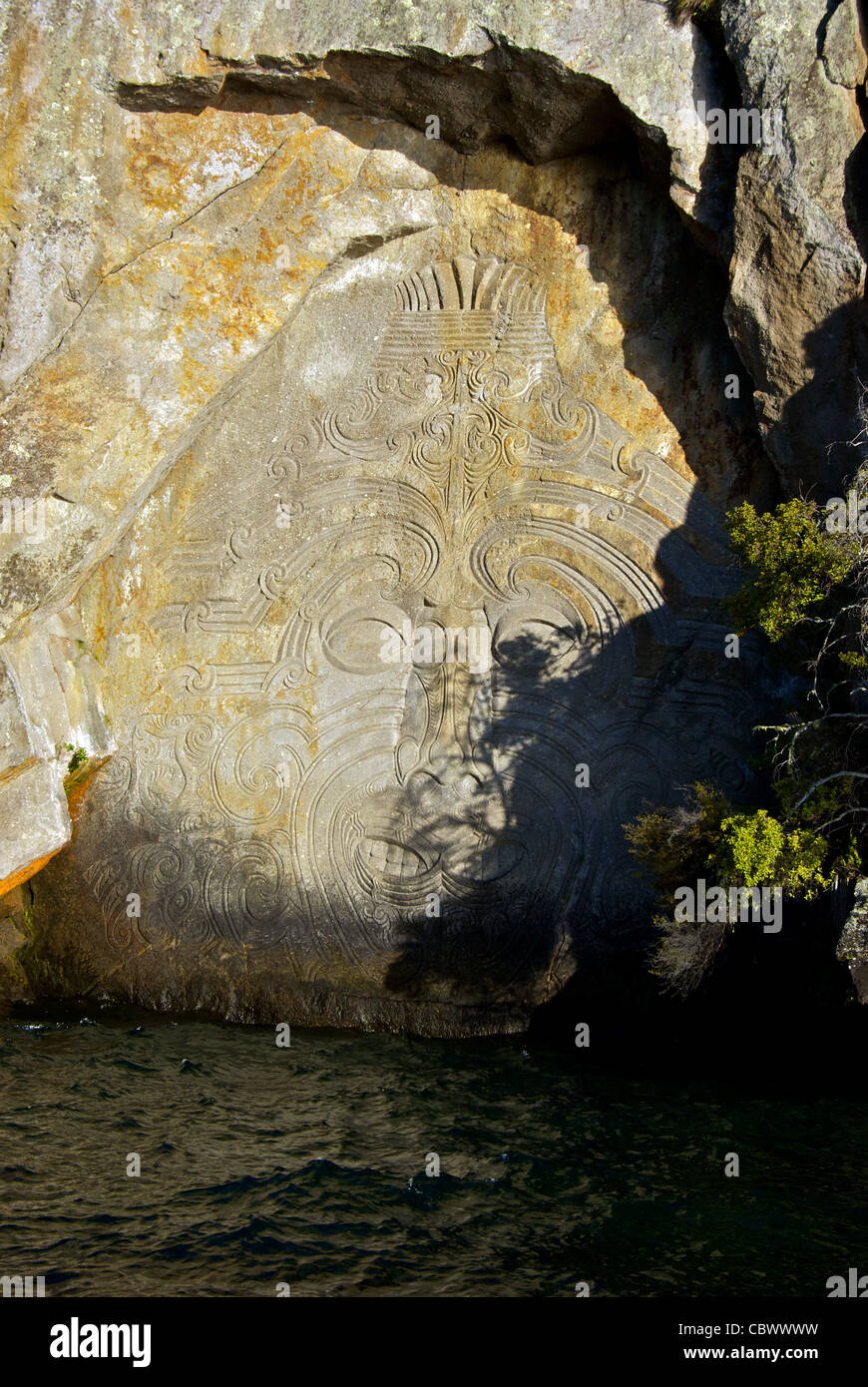 Modern Maori rock carvings depicting God of Volcanoes Great Lake Taupo New Zealand Stock Photo