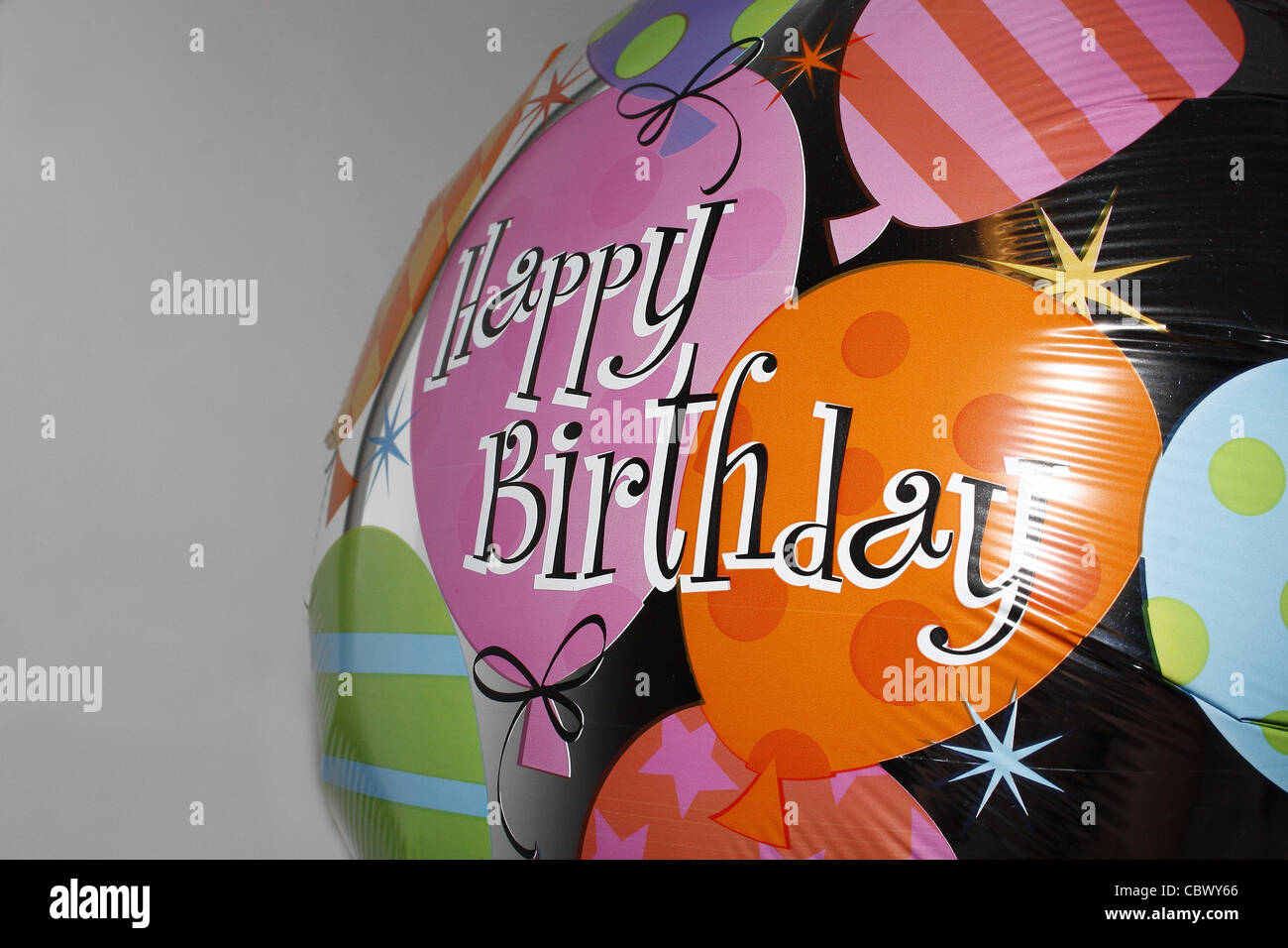 happy birthday helium balloon against plain background Stock Photo - Alamy