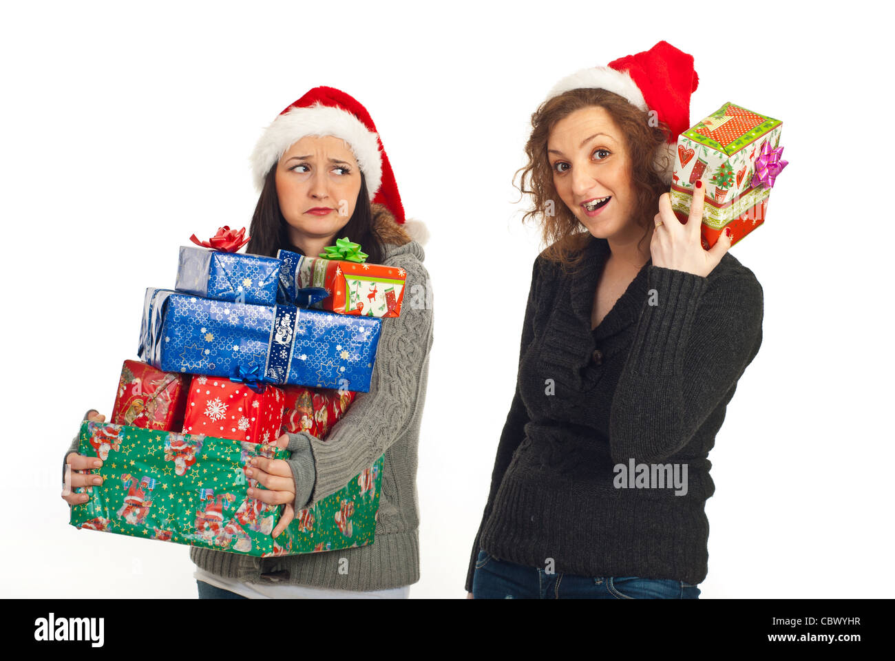 Funny two women holding Christmas gifts isolated on white background