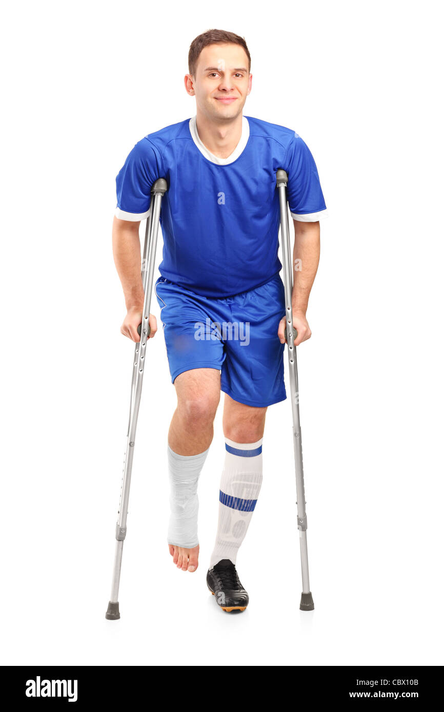 Full length portrait of an injured soccer football player on crutches