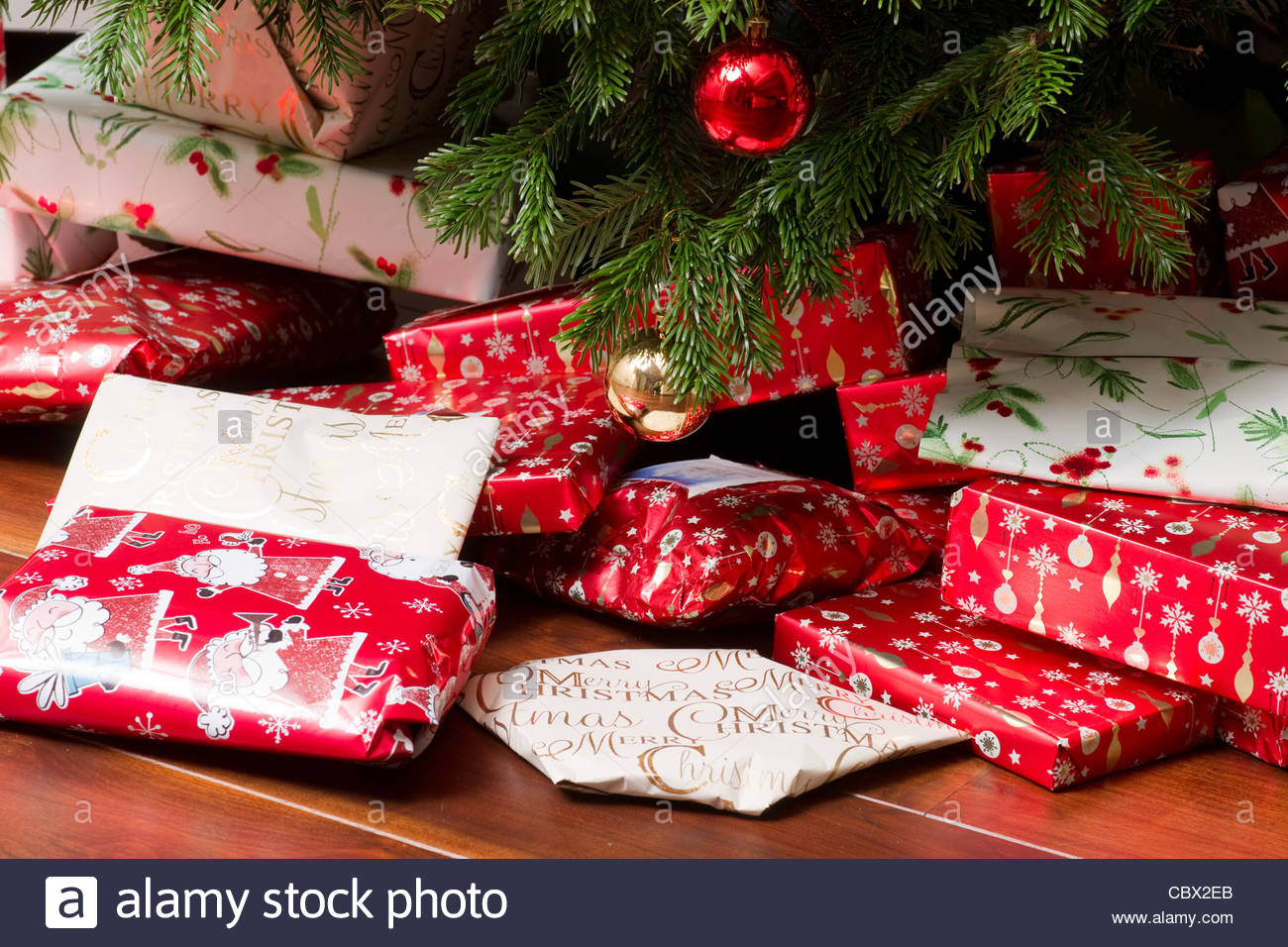 Christmas presents underneath a pine tree in a modern living room Stock Image