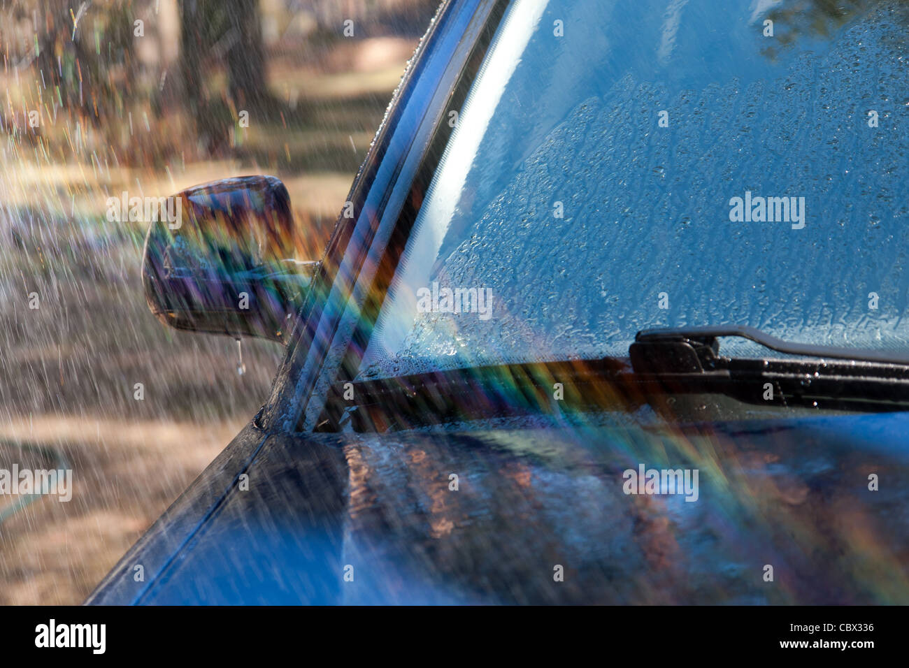 Car Wash Car Front Window, Mirror and Jet of Water, Waterdrops Stock