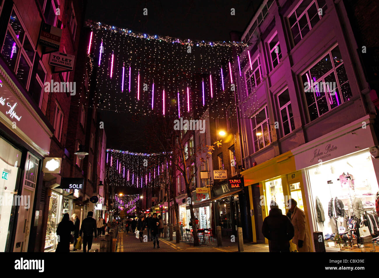 Pink Christmas lights and decorations at Seven Dials in Covent Garden in London Stock Photo