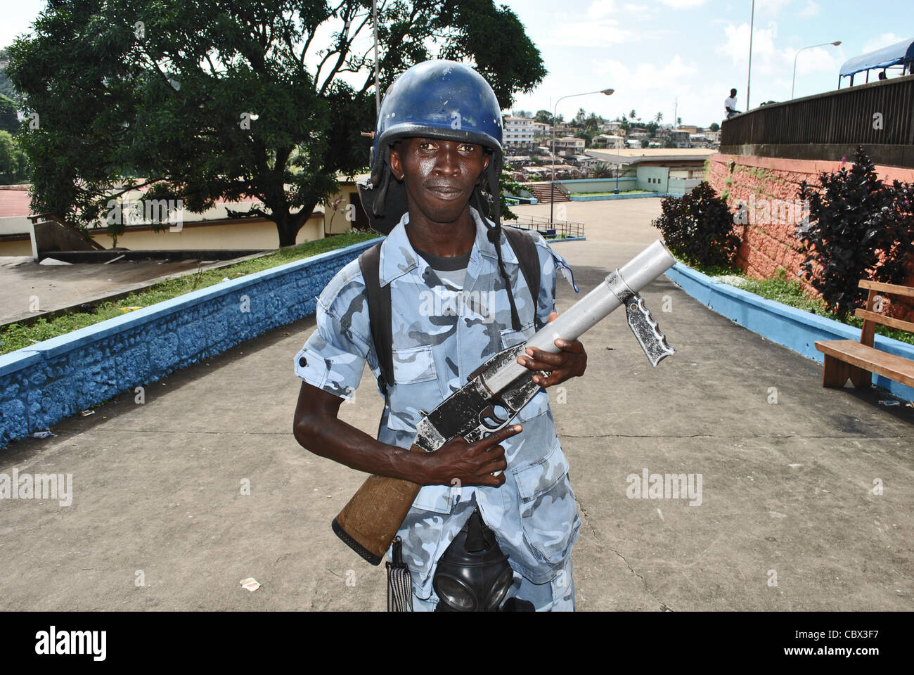 Policeman armed with teargas at the football stadium in Freetown, Sierra Leone Stock Photo