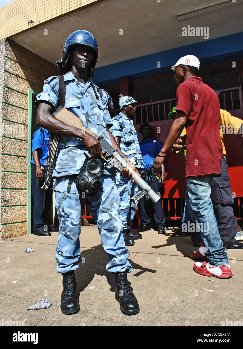 Policeman armed with teargas at the football stadium in Freetown, Sierra Leone Stock Photo