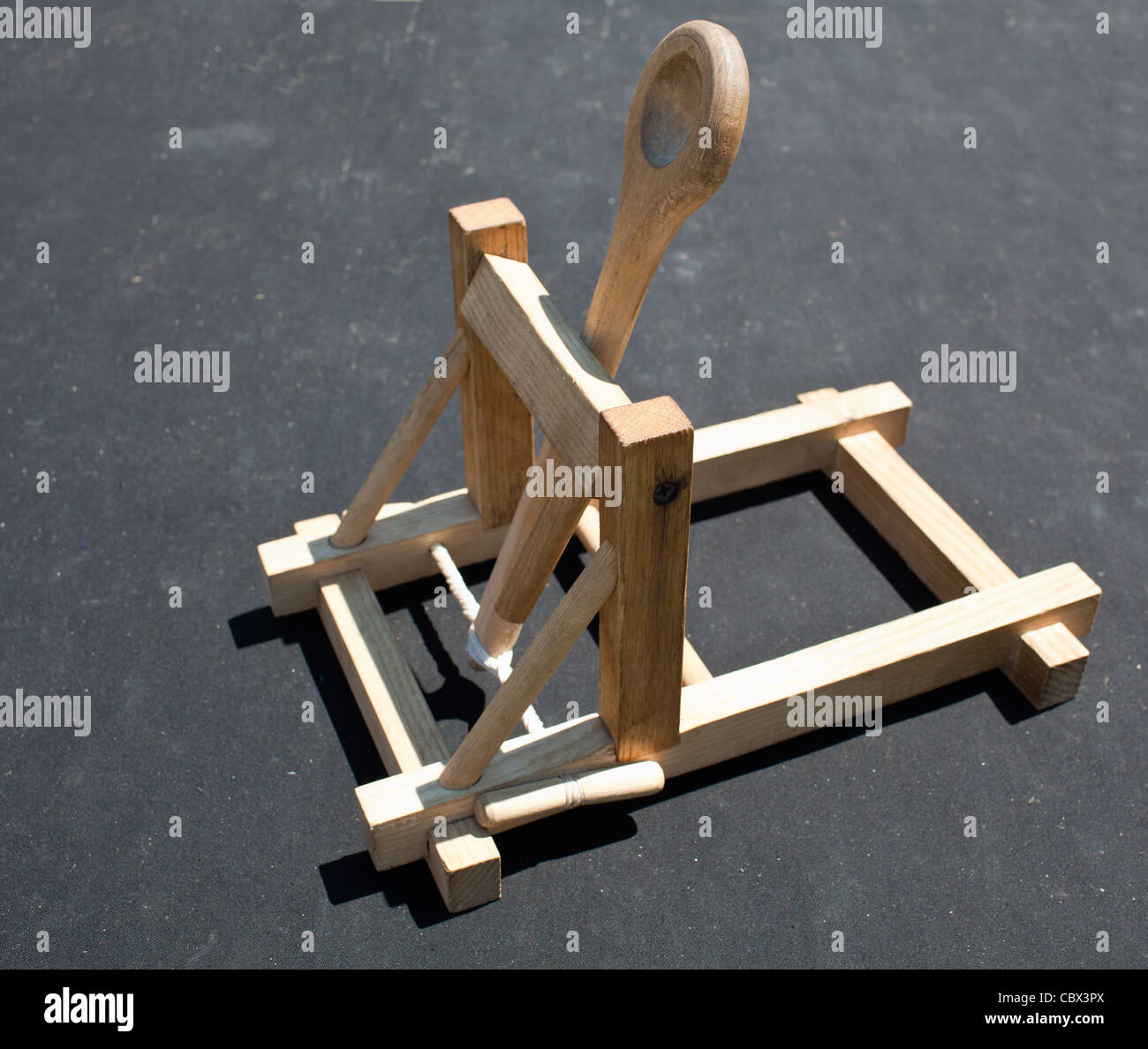 Wooden catapult toy on dark background Stock Photo