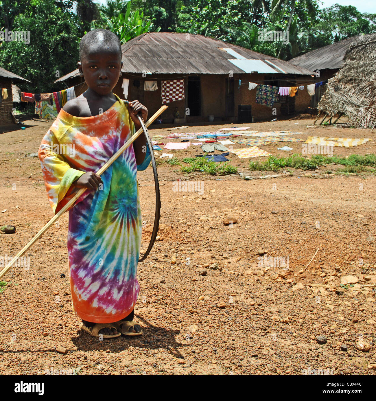 Child in a colourful tie-dyed shirt near Kenema, Sierra Leone Stock Photo