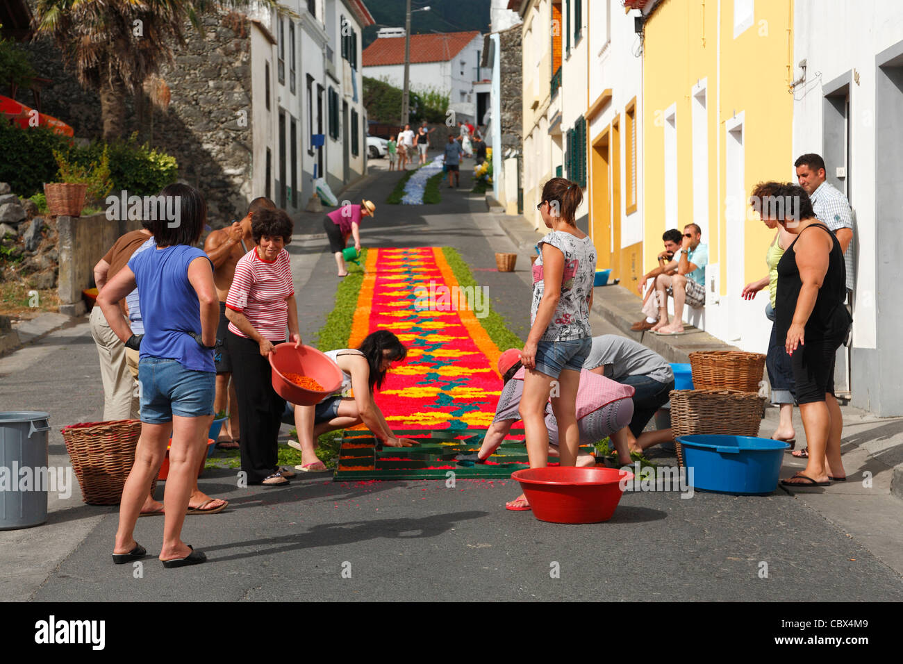 Local residents making flower carpets, in the parish of Ponta Garça. Sao Miguel island, Azores. Stock Photo