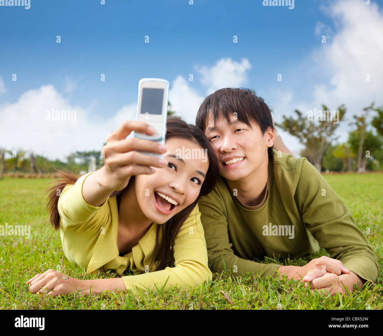 asian couple taking photo by smart mobile phone Stock Photo - Alamy